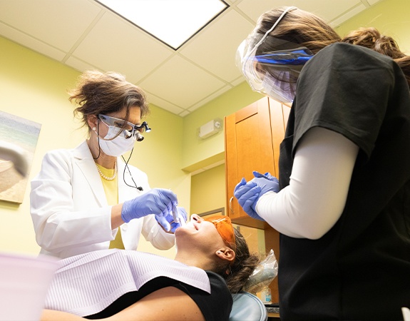 Dentist and team member treating dental patient