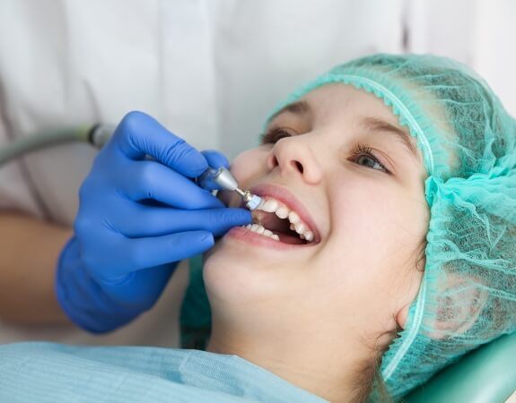 Patient receiving dental checkup and teeth cleaning