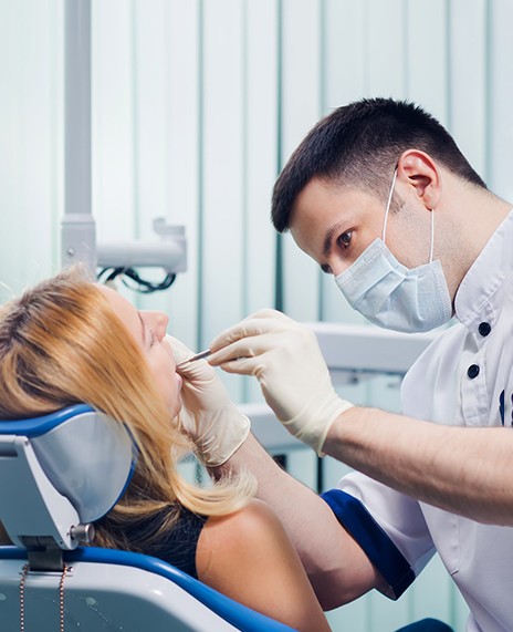 Dentist looking in woman’s mouth