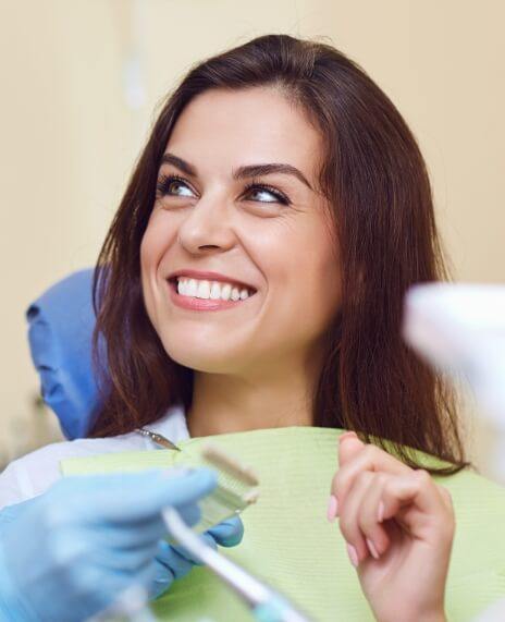 Patient discussing tooth replacement with dental implants with dentist