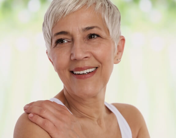 Woman sharing smile after discussing the cost of dental implants