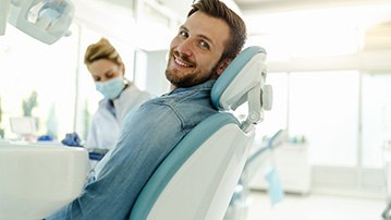 Man smiling while sitting in treatment chair