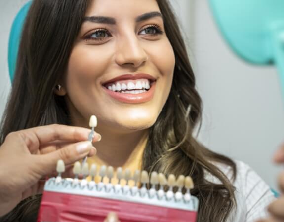 Woman's smile compared to metal free dental crown shade options