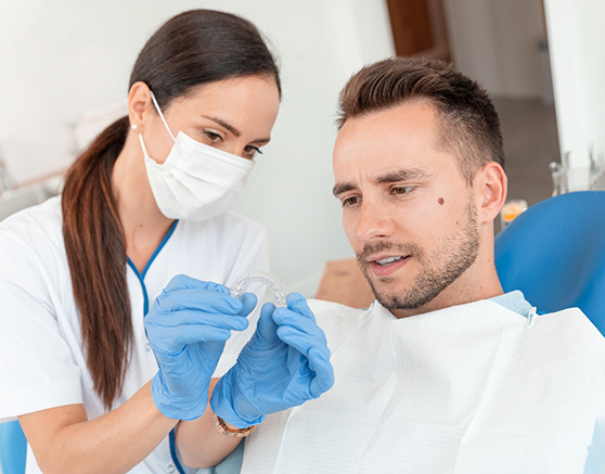 A dentist answering questions about Invisalign in Marlboro