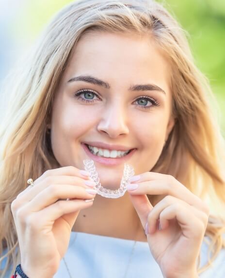 Woman placing a clear orthodontics tray