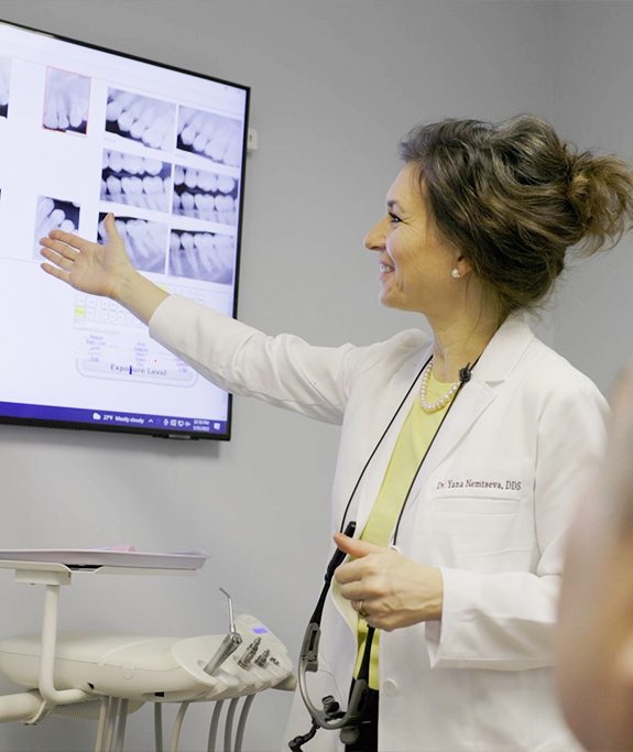 Doctor Nemtseva pointing to dental x-rays