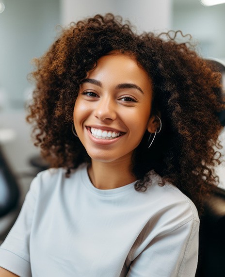 Closeup of young woman smiling while sitting in dental chair