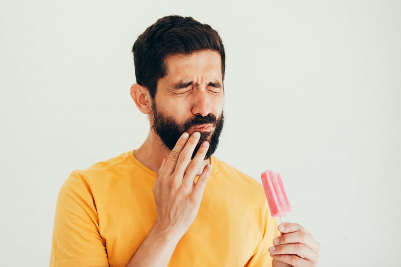 A man experiencing tooth sensitivity